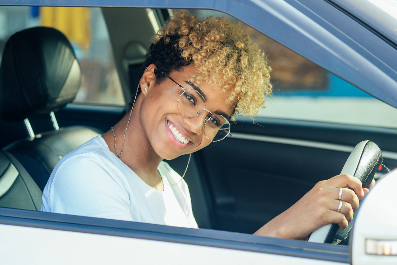 Woman inside of a car smiling